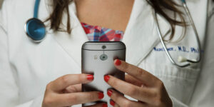 Female Doctor using a mobile phone for telehealth services