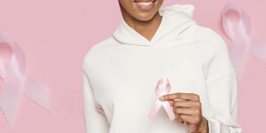 Woman holding a breast cancer ribbon